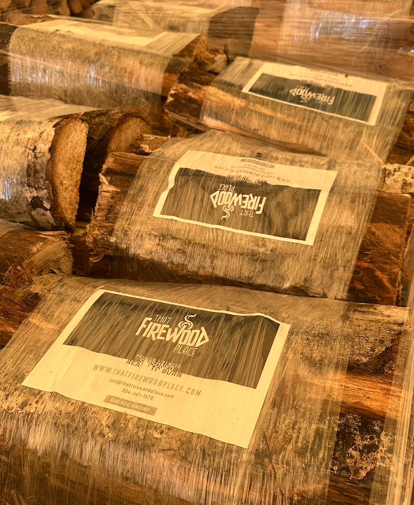 Shrink-wrapped firewood bundles stored indoors, That Firewood Place, Woodlands MB