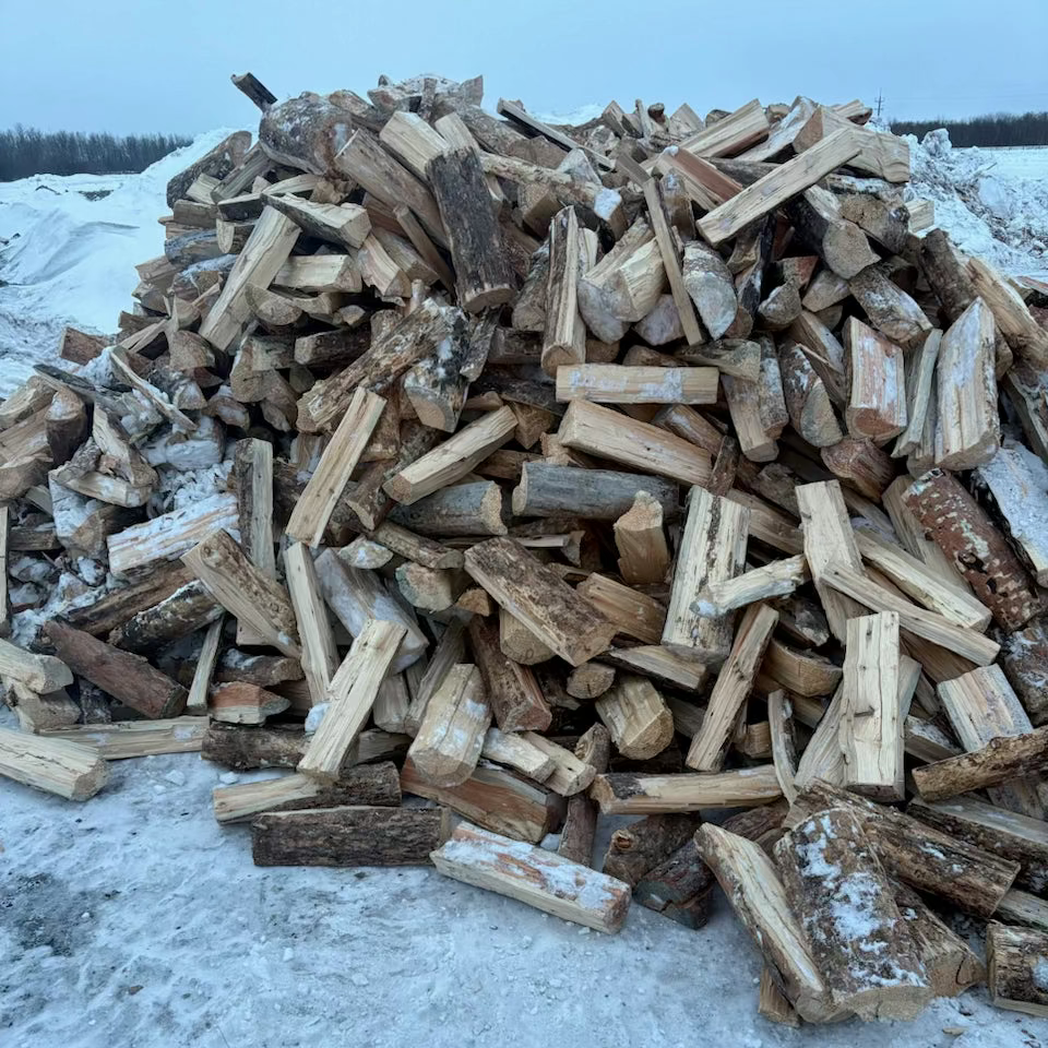 Stack of firewood on a snowy ground